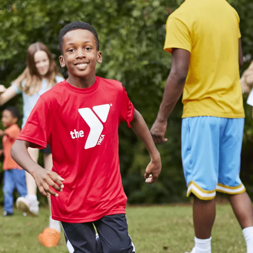 A boy runs during outside game.