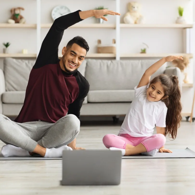 father and daughter doing yoga