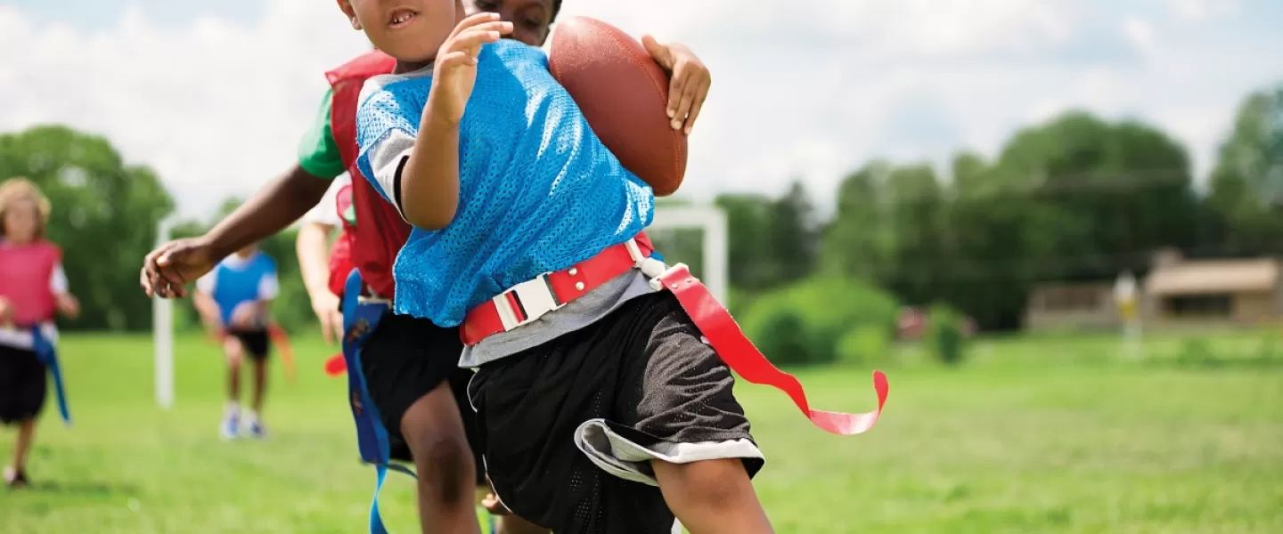 flag football playing running with the ball