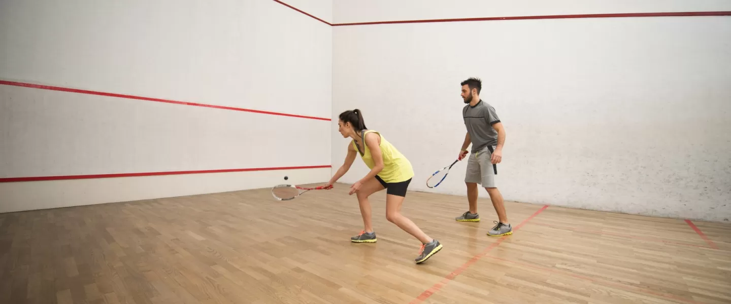 Two people play pickleball